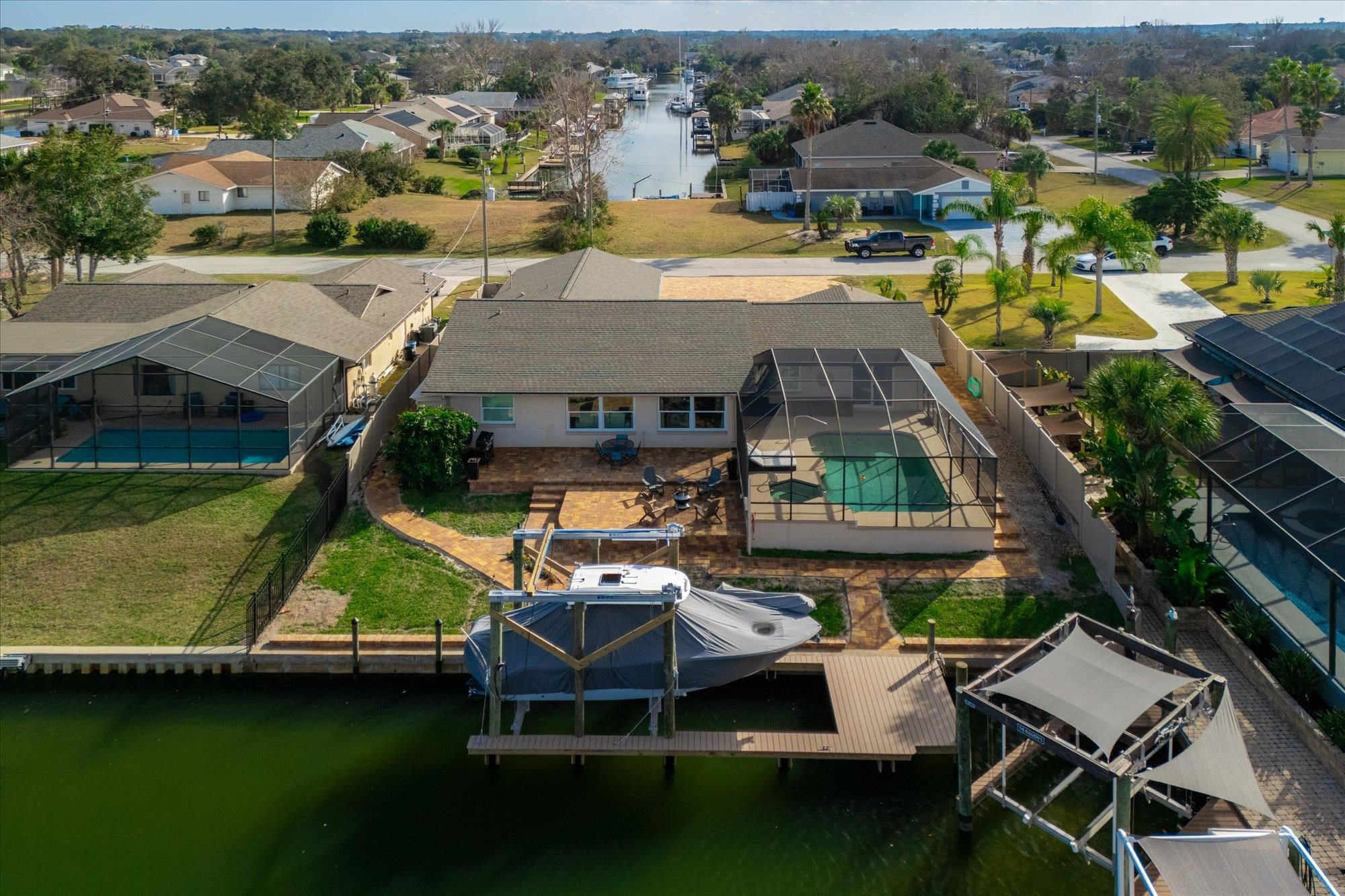 5 Cheyenne Court Palm Coast, FL 32137 - Photo 49 of 58 an aerial view of a house with swimming pool patio and lake view
