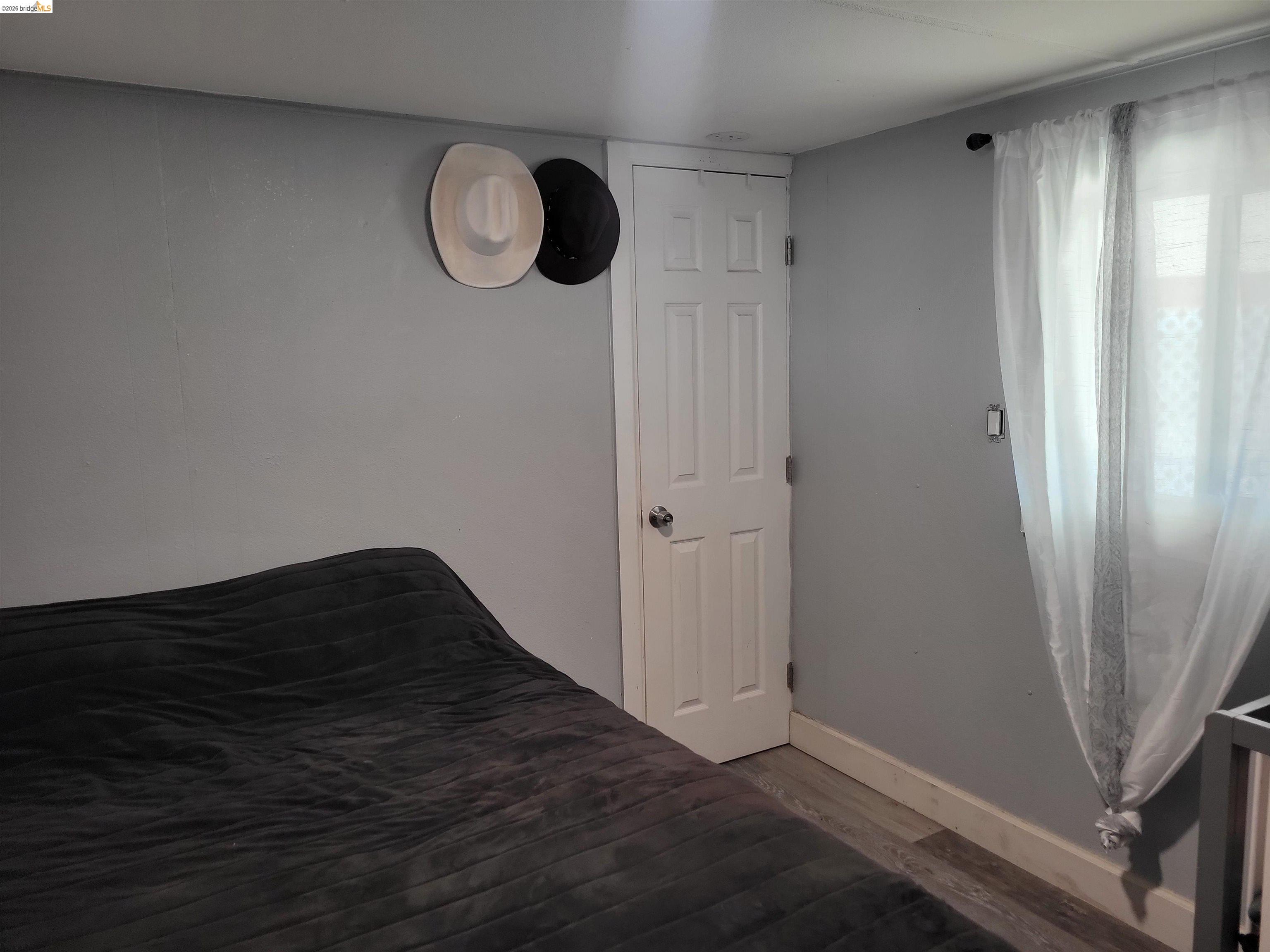 4400 Gateway Road, Unit 38 Bethel Island, CA 94511 - Photo 5 of 5 Unfurnished bedroom featuring baseboards and wood finished floors