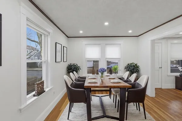 a view of a dining room with furniture window and wooden floor