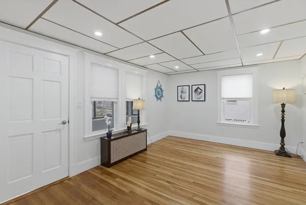 a view of empty room with wooden floor