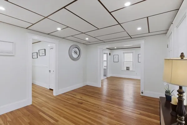 a view of an empty room with wooden floor