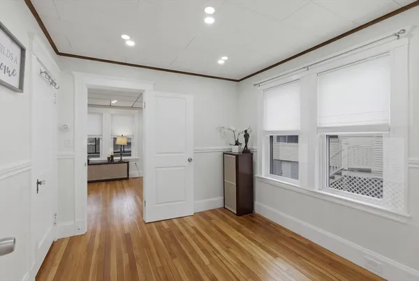 a view of hallway with wooden floor