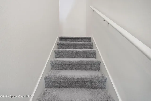 a view of staircase with white walls