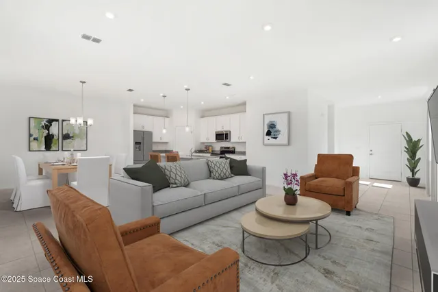 a living room with furniture and view of kitchen