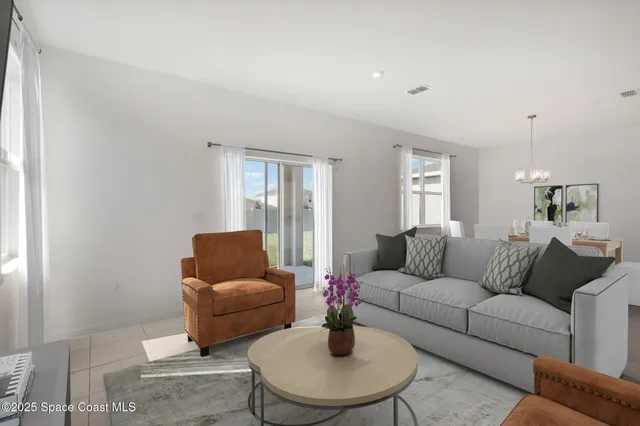 a living room with furniture and a potted plant