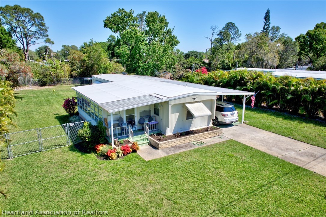 a view of a house with a backyard and a patio