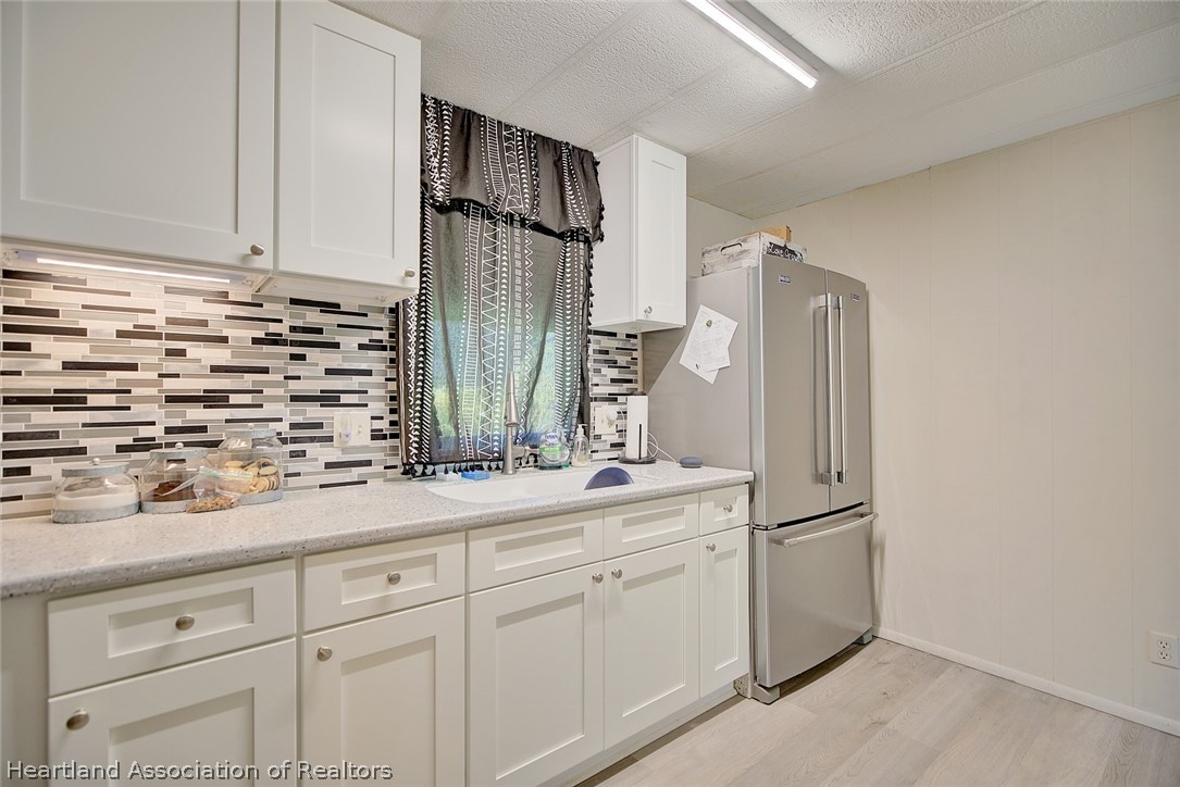 310 Pine Tree Lane Sebring, FL 33872 - Photo 2 of 28 a kitchen with a refrigerator and a sink