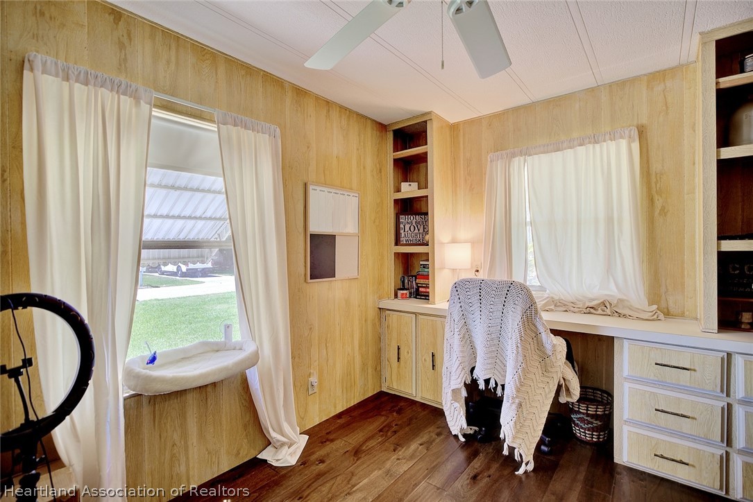 310 Pine Tree Lane Sebring, FL 33872 - Photo 22 of 28 a view of a bedroom with a window and wooden floor