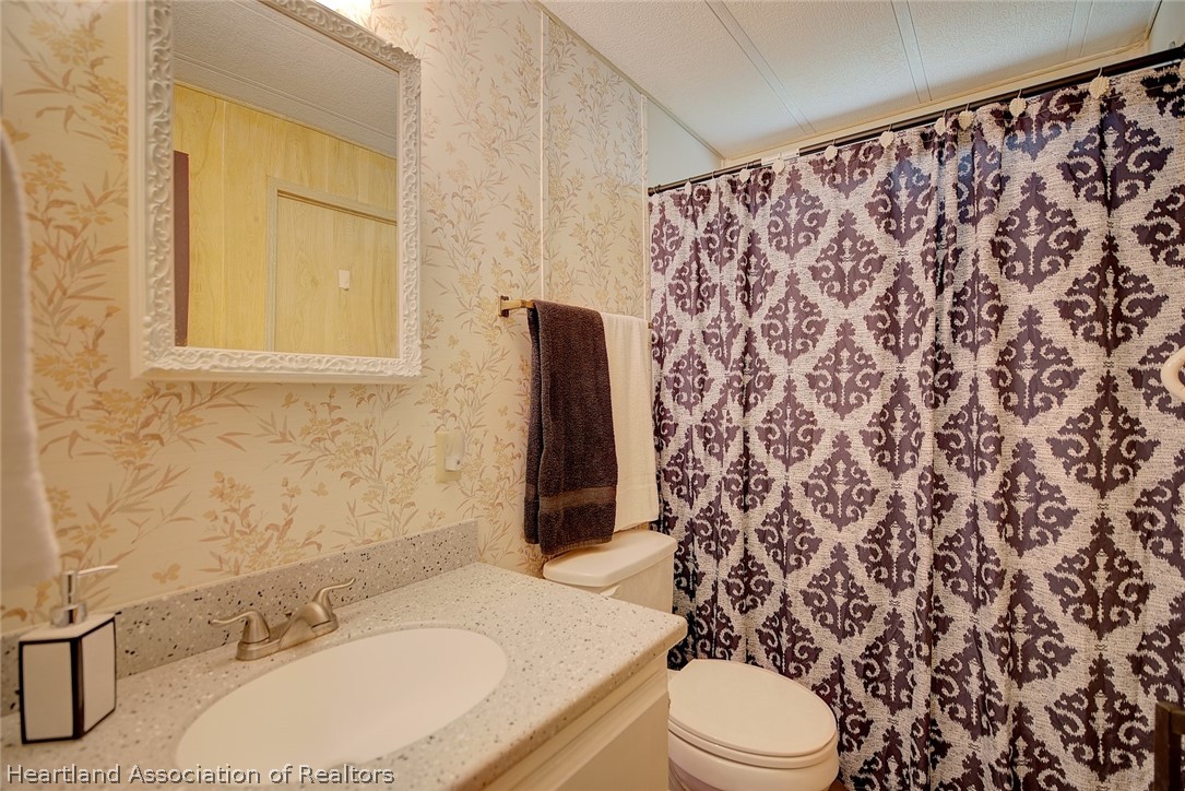 310 Pine Tree Lane Sebring, FL 33872 - Photo 23 of 28 a bathroom with a sink and a mirror