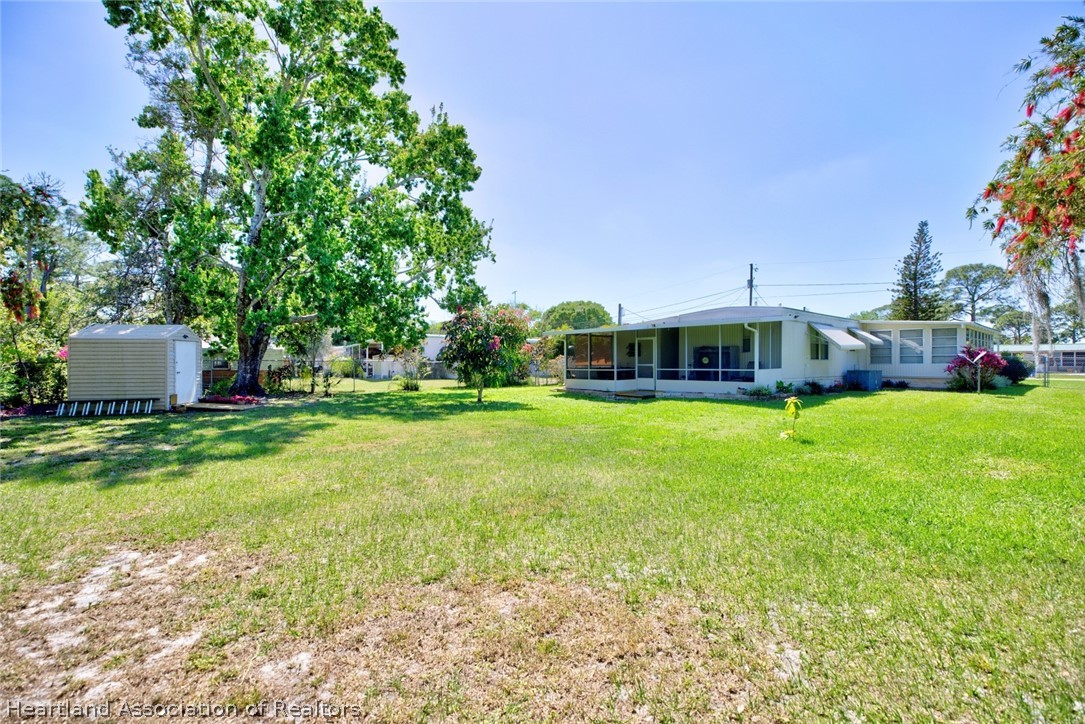 310 Pine Tree Lane Sebring, FL 33872 - Photo 26 of 28 a front view of house with yard and green space