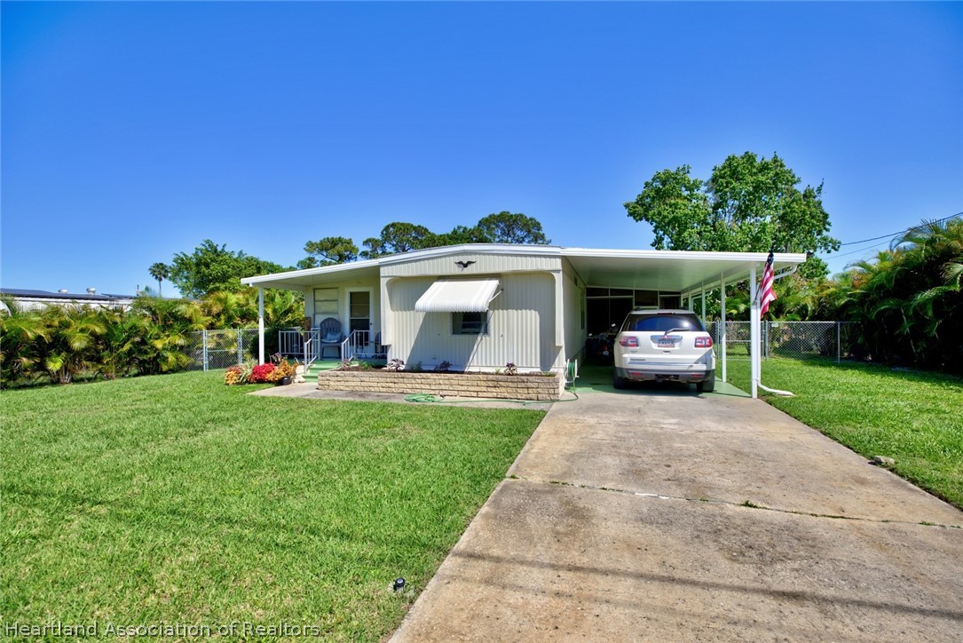 310 Pine Tree Lane Sebring, FL 33872 - Photo 27 of 28 a view of a house with garden and street view
