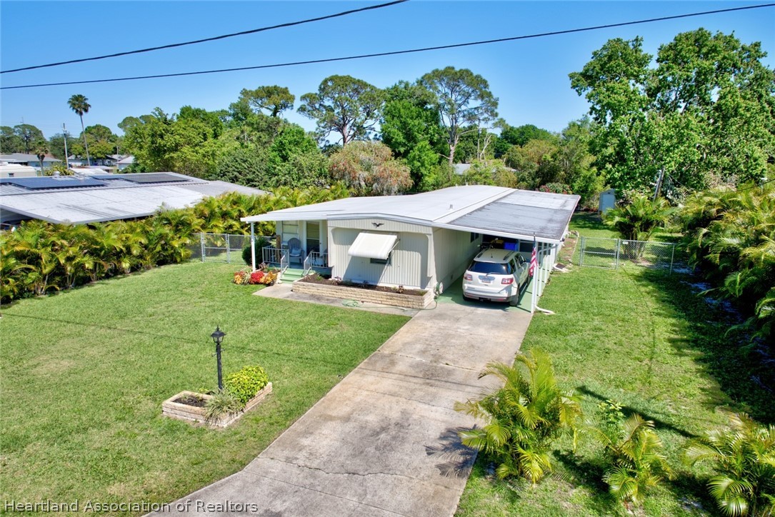 310 Pine Tree Lane Sebring, FL 33872 - Photo 28 of 28 a front view of a house with a yard