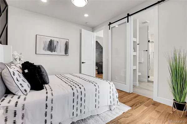 a bedroom with a bed and a potted plant