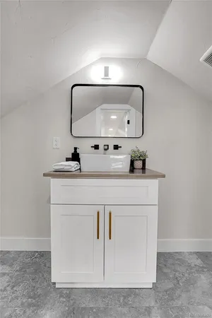 a bathroom with a sink vanity and mirror