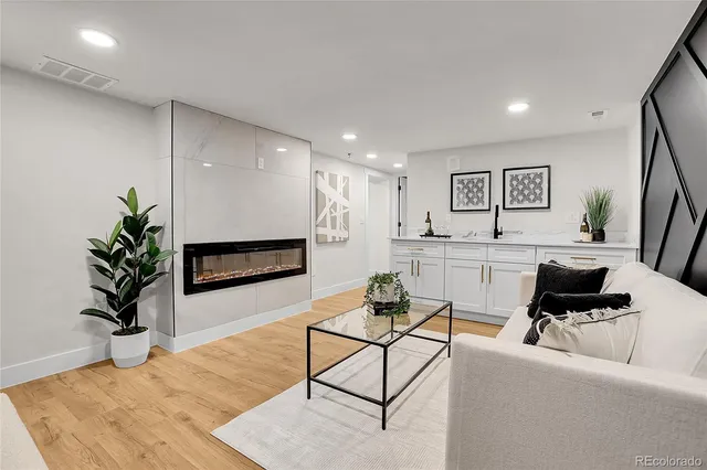 a living room with furniture and a potted plant