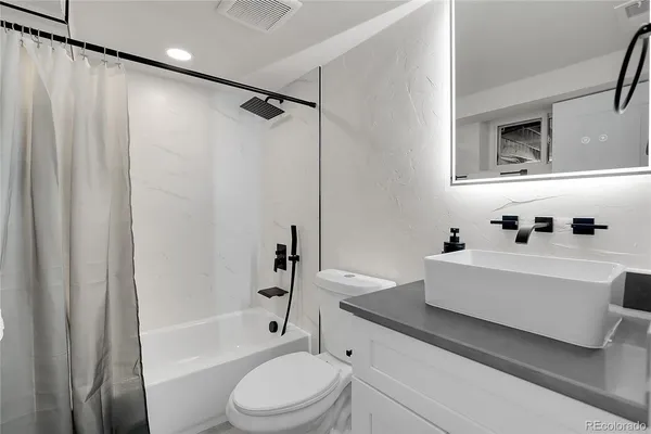 a bathroom with a sink a toilet and a bathtub