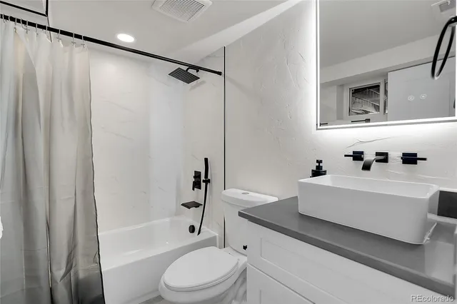 a bathroom with a sink a toilet and a bathtub