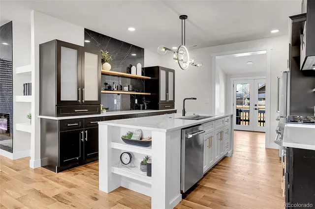 a kitchen with stainless steel appliances a stove and a refrigerator