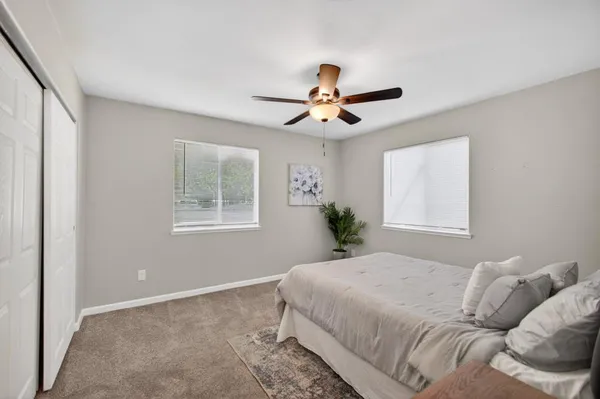 a bedroom with a bed and window