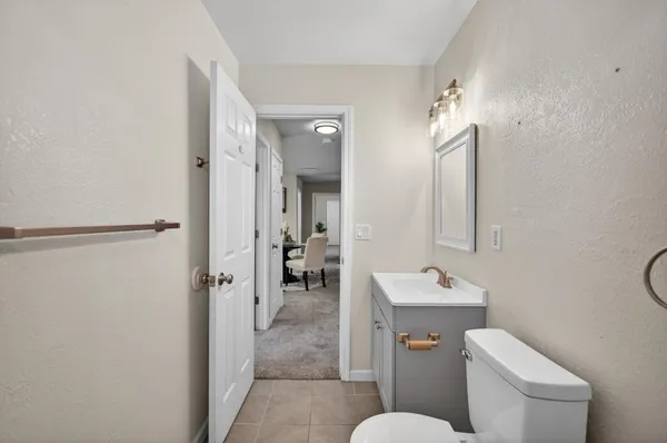 a bedroom with a bed ceiling fan and window