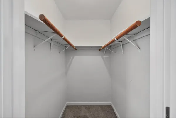 a bedroom with a bed and a chandelier fan