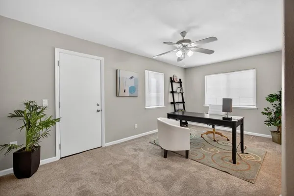 a living room with furniture a window and a chandelier