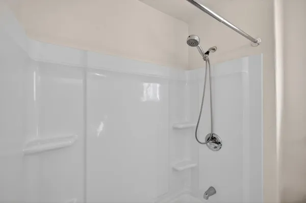 a front view of a house with a yard and potted plants