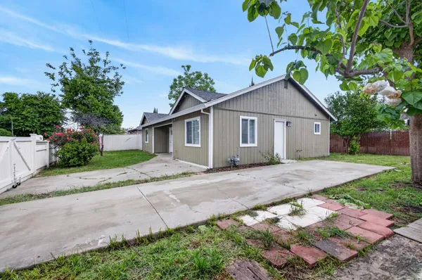 a front view of a house with a garden