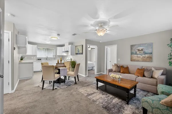 a living room with furniture and a chandelier