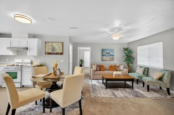 a living room with furniture and a large window