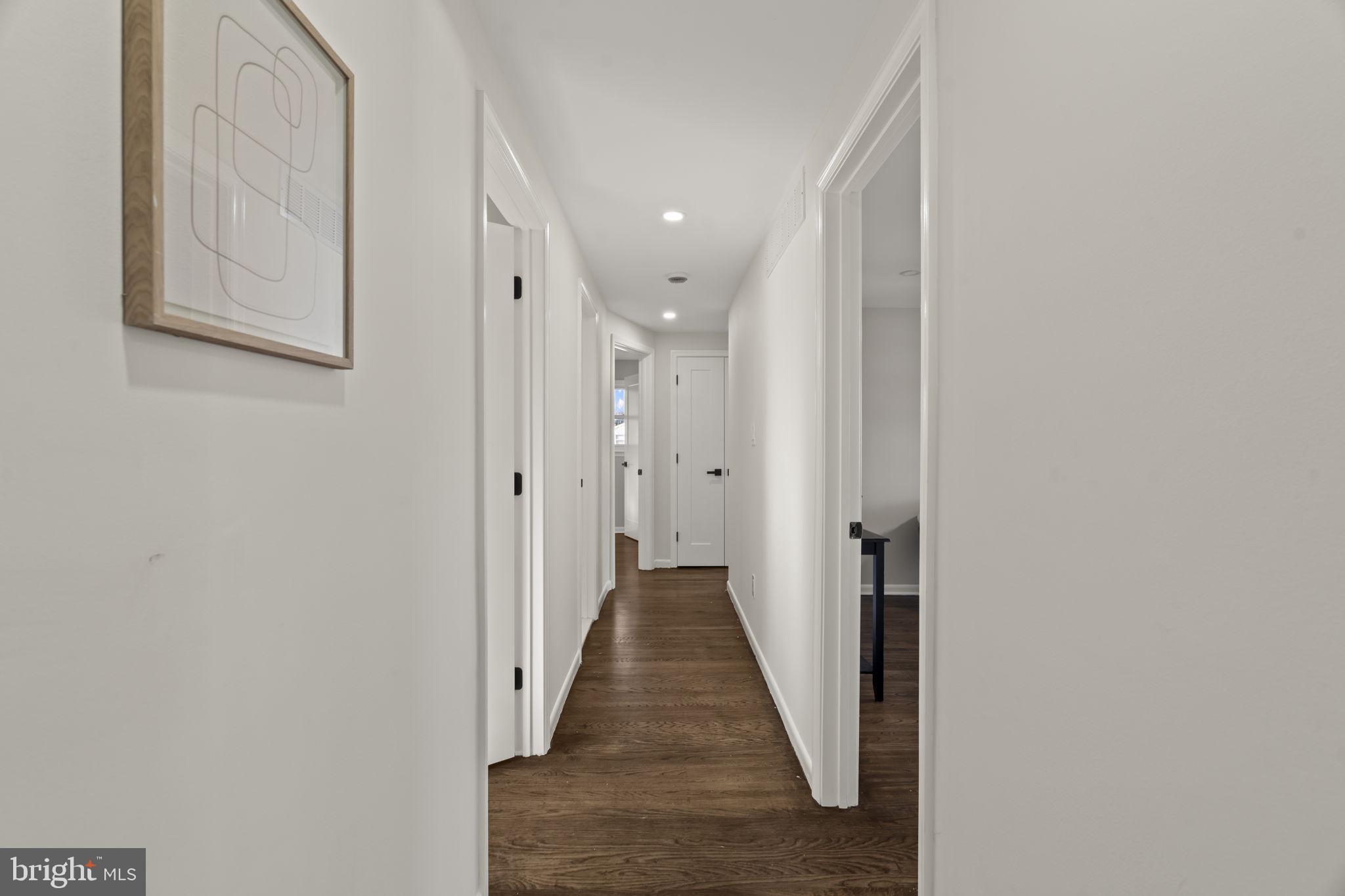 33 Millbridge Road Clementon, NJ 08021 - Photo 22 of 34 a view of a hallway with wooden floor and a bathroom