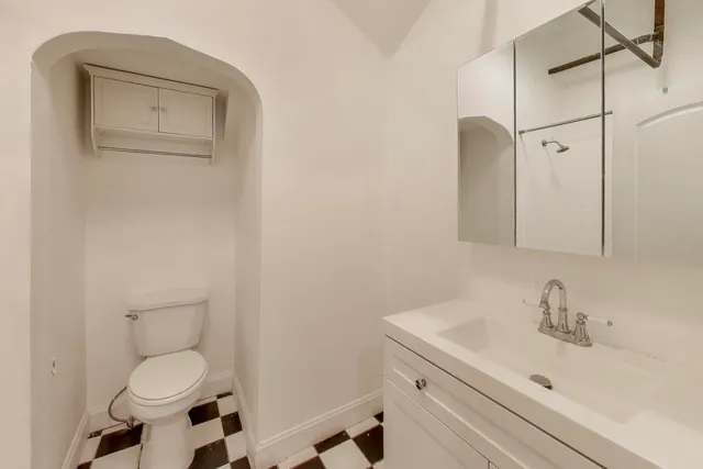 a bathroom with a sink toilet and vanity