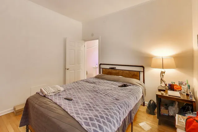 a bedroom with a bed and a table