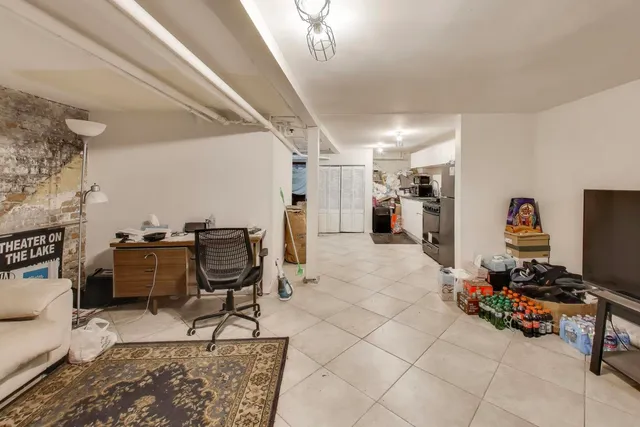 a view of a livingroom with workspace and a window