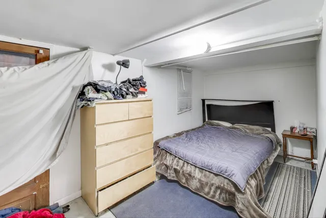 a bedroom with a bed and a dresser