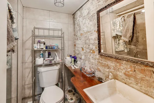 a white toilet sitting next to a bathroom sink