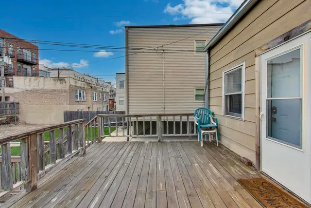a view of a balcony with wooden floor