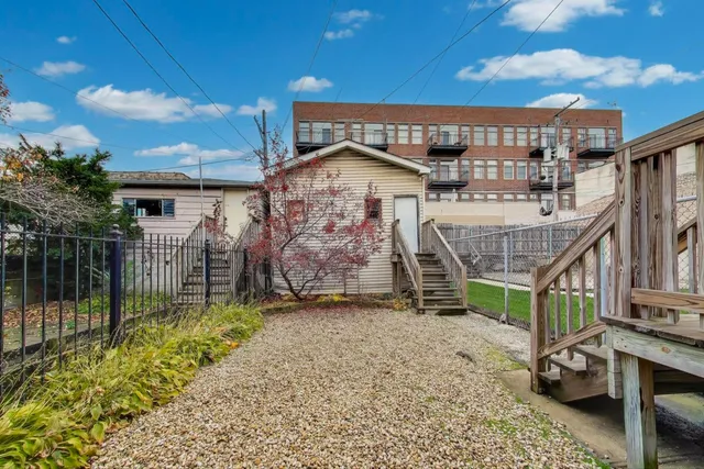a view of a house with a wooden fence
