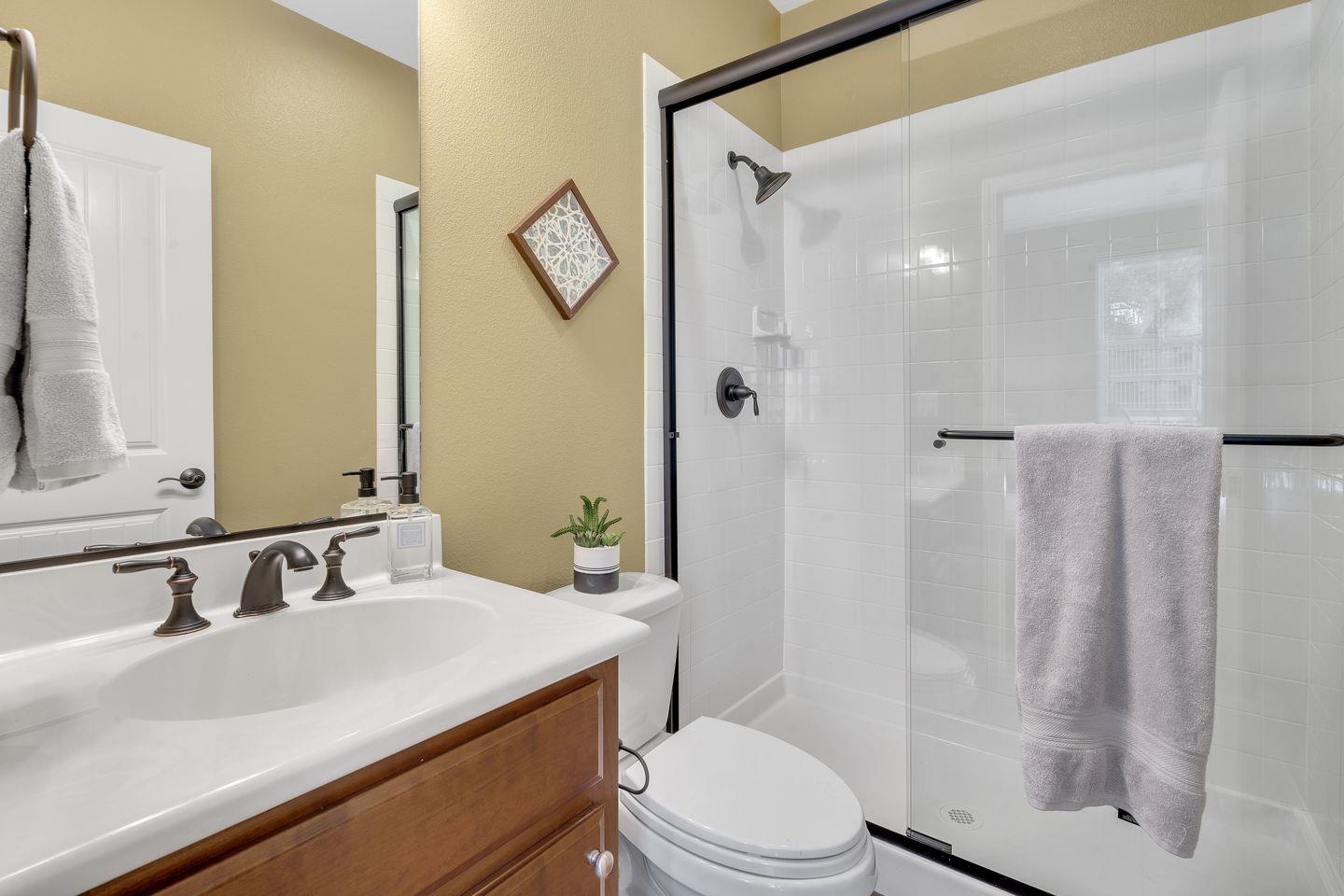 129 Azalea Drive Mountain View, CA 94041 - Photo 21 of 53 a bathroom with a sink a toilet a mirror and shower