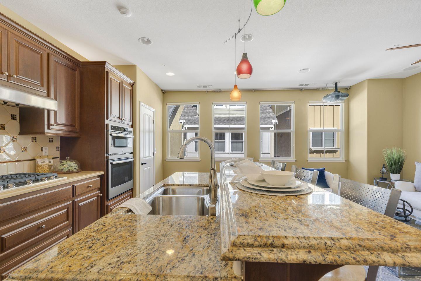 129 Azalea Drive Mountain View, CA 94041 - Photo 35 of 53 a kitchen with stainless steel appliances kitchen island granite countertop a stove and cabinets