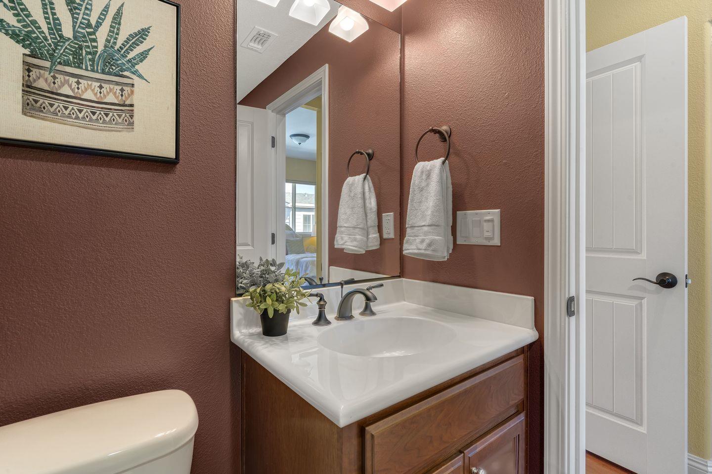 129 Azalea Drive Mountain View, CA 94041 - Photo 52 of 53 a bathroom with a granite countertop sink and a mirror with toilet