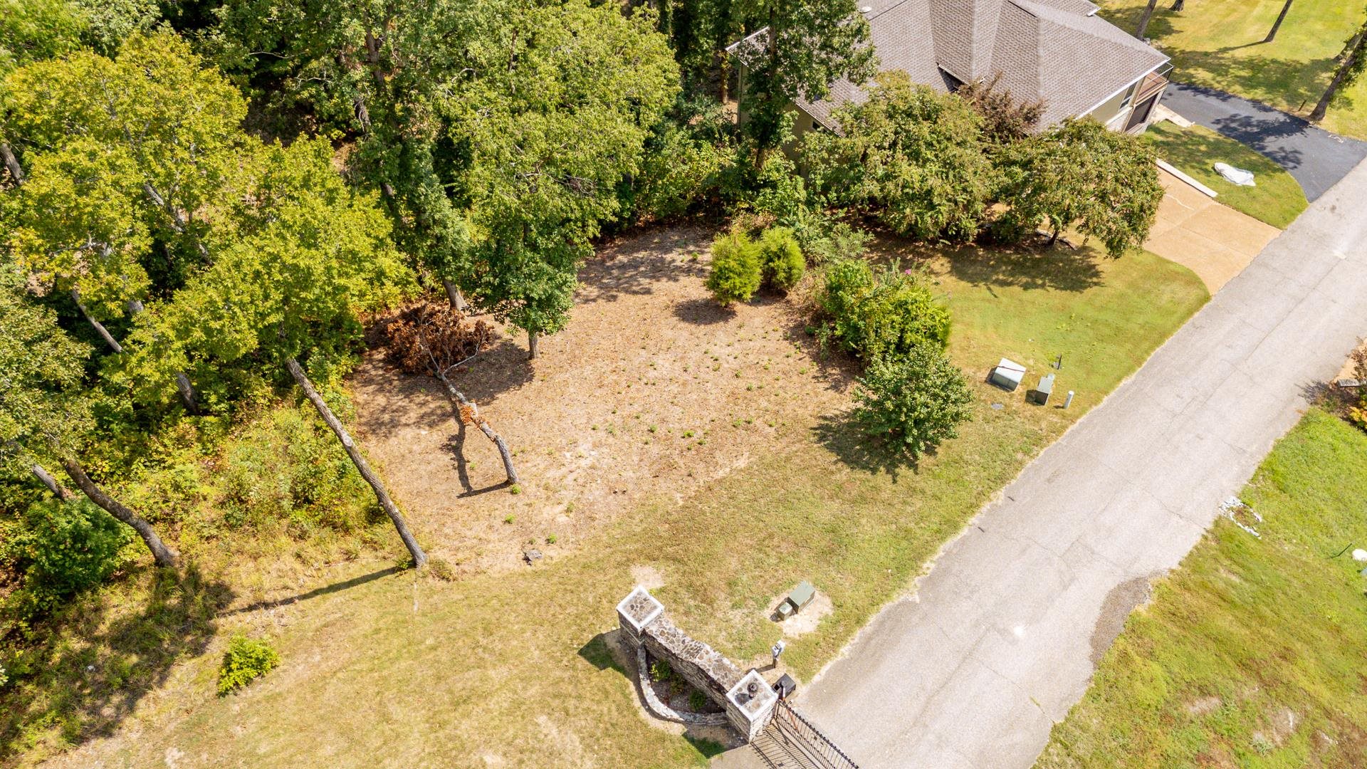 0 Quarry Hollow Pnt Road Savannah, TN 38372 - Photo 9 of 30 a view of a swimming pool with a lawn chairs under an umbrella