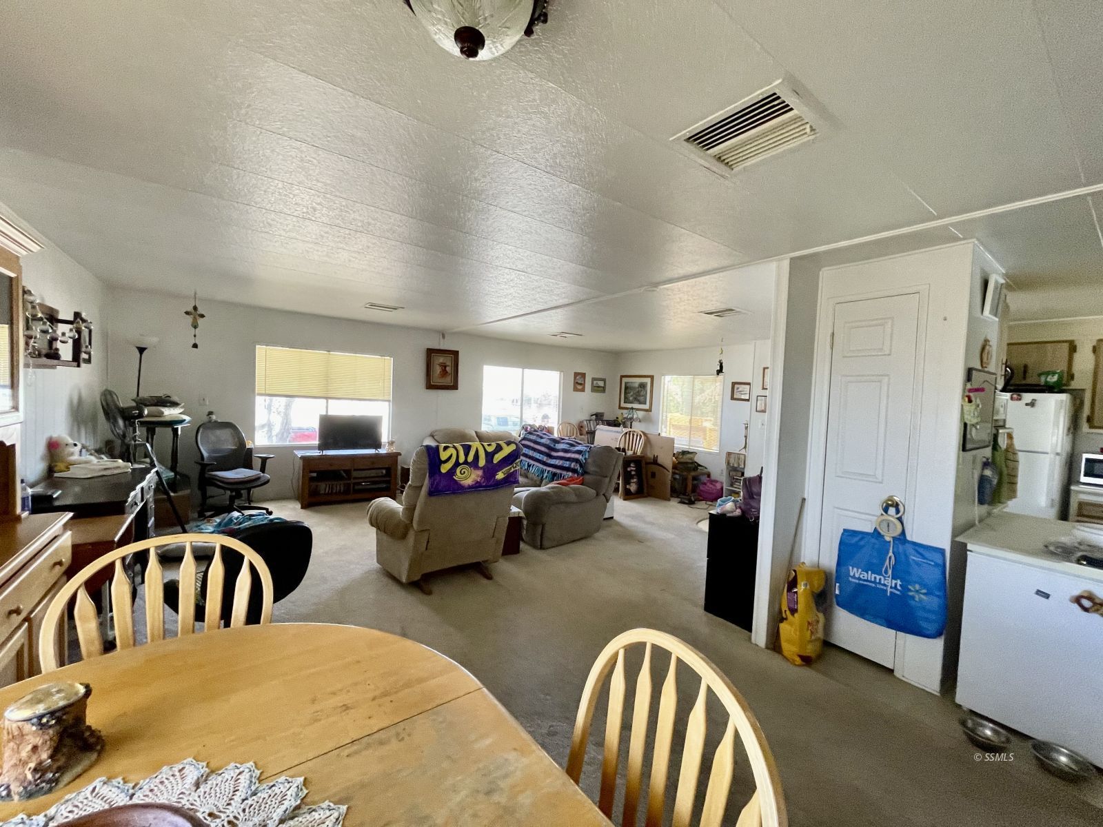 5237 Nolina Avenue Ridgecrest, CA 93555 - Photo 6 of 27 a living room with lots of furniture and a view of bedroom
