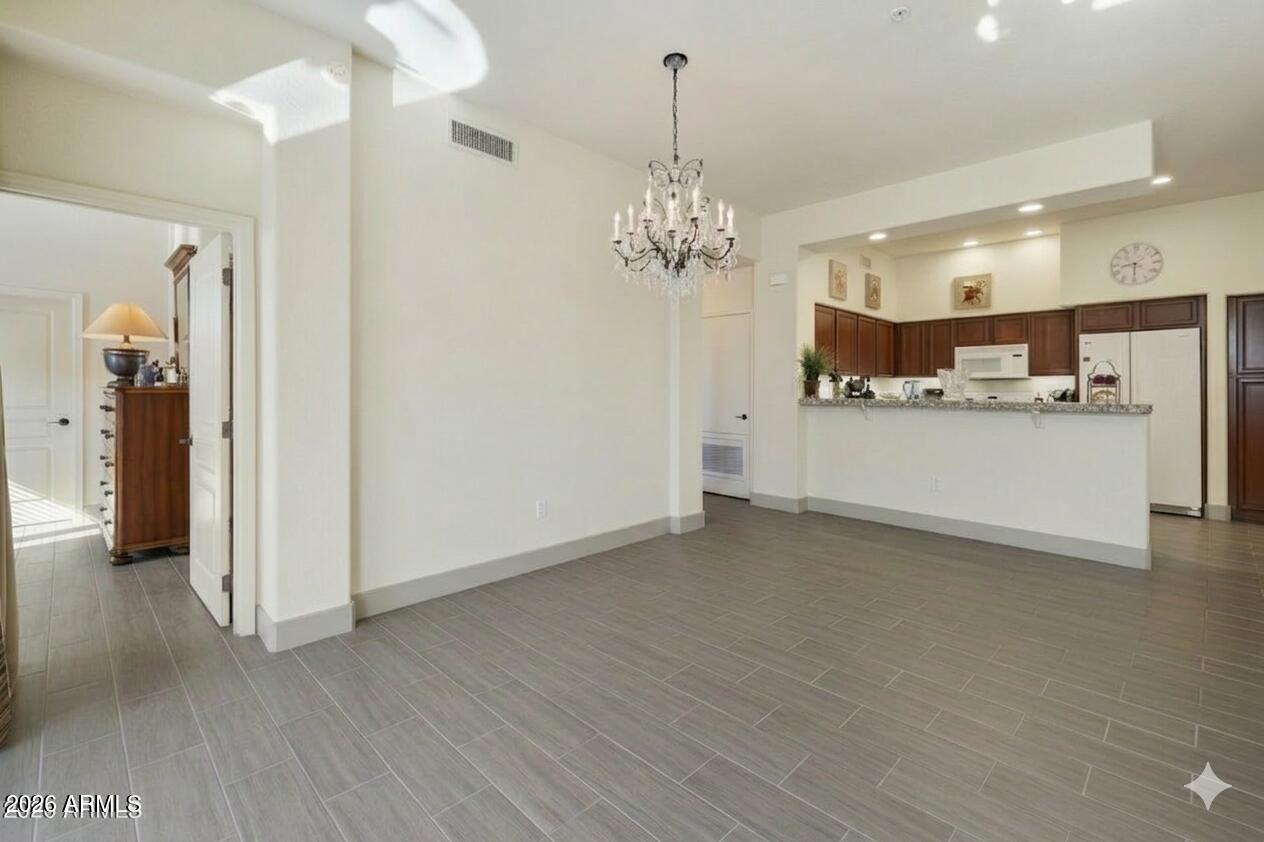 2989 North 44th Street, Unit 3018 Phoenix, AZ 85018 - Photo 13 of 45 a view of a kitchen with a sink stainless steel appliances and chandelier