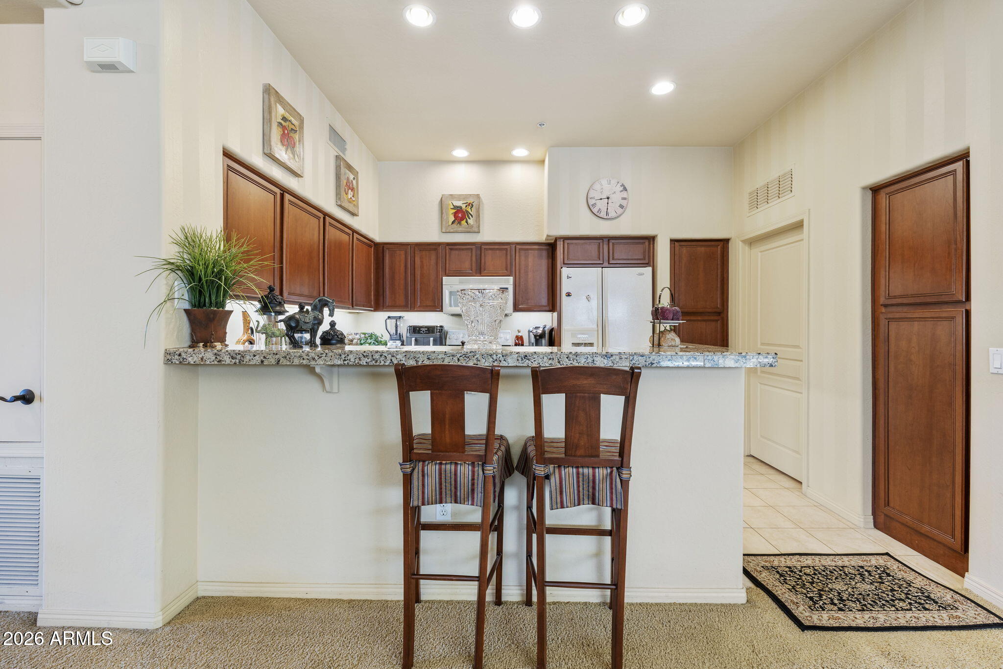 2989 North 44th Street, Unit 3018 Phoenix, AZ 85018 - Photo 14 of 45 a kitchen with kitchen island granite countertop a refrigerator and a sink