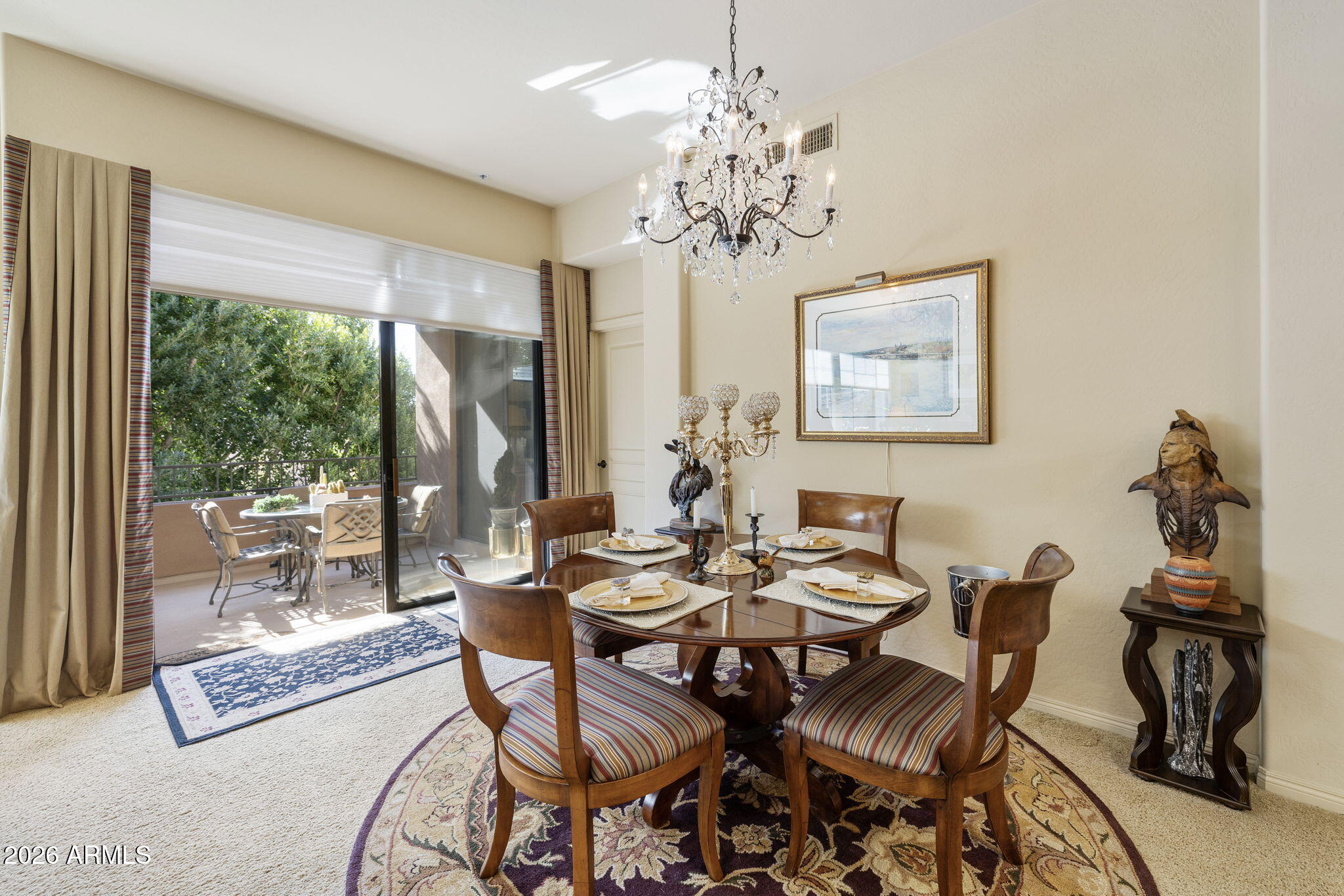 2989 North 44th Street, Unit 3018 Phoenix, AZ 85018 - Photo 18 of 45 a dining room with furniture a large window and a chandelier