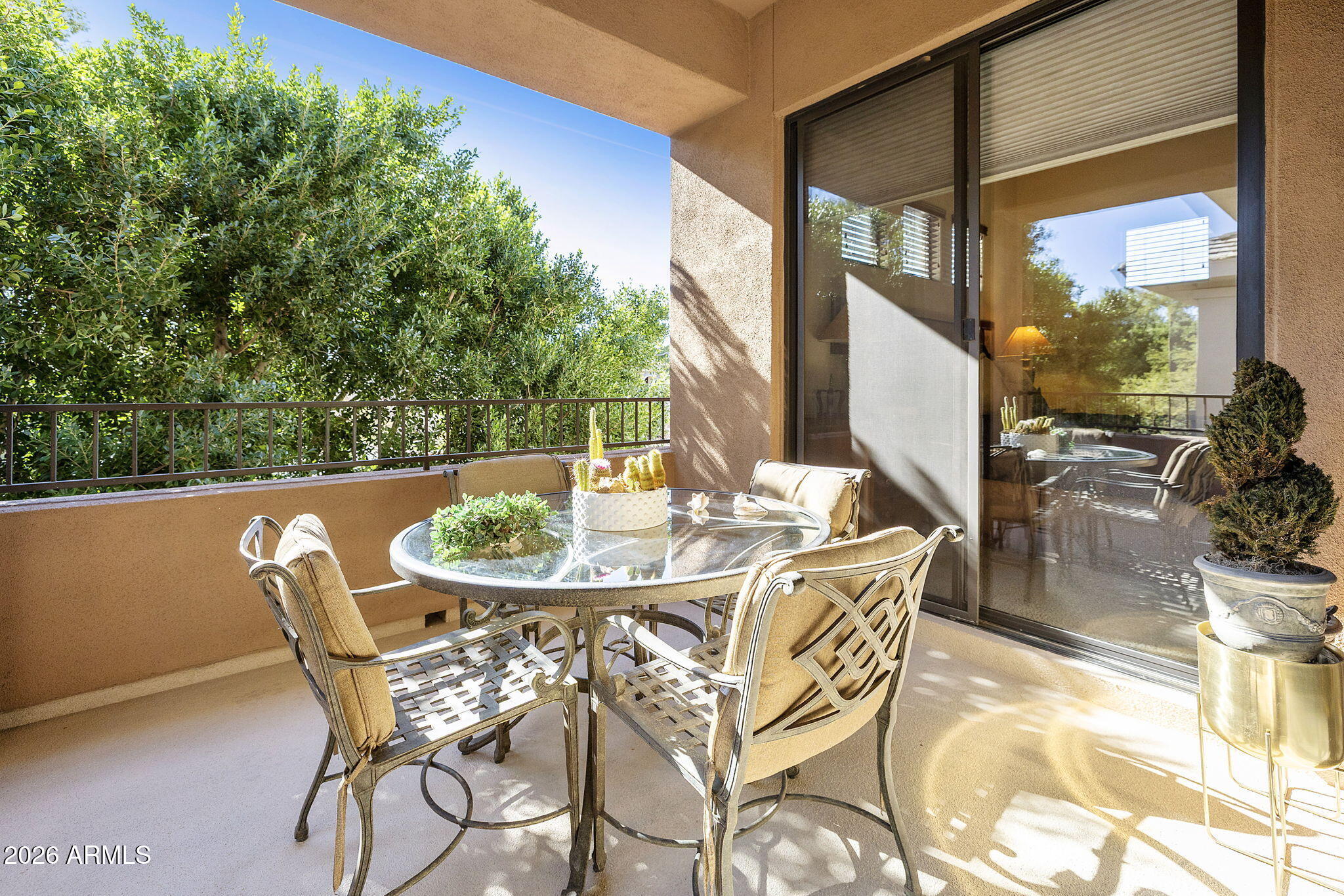 2989 North 44th Street, Unit 3018 Phoenix, AZ 85018 - Photo 19 of 45 a patio with table and chairs and potted plants