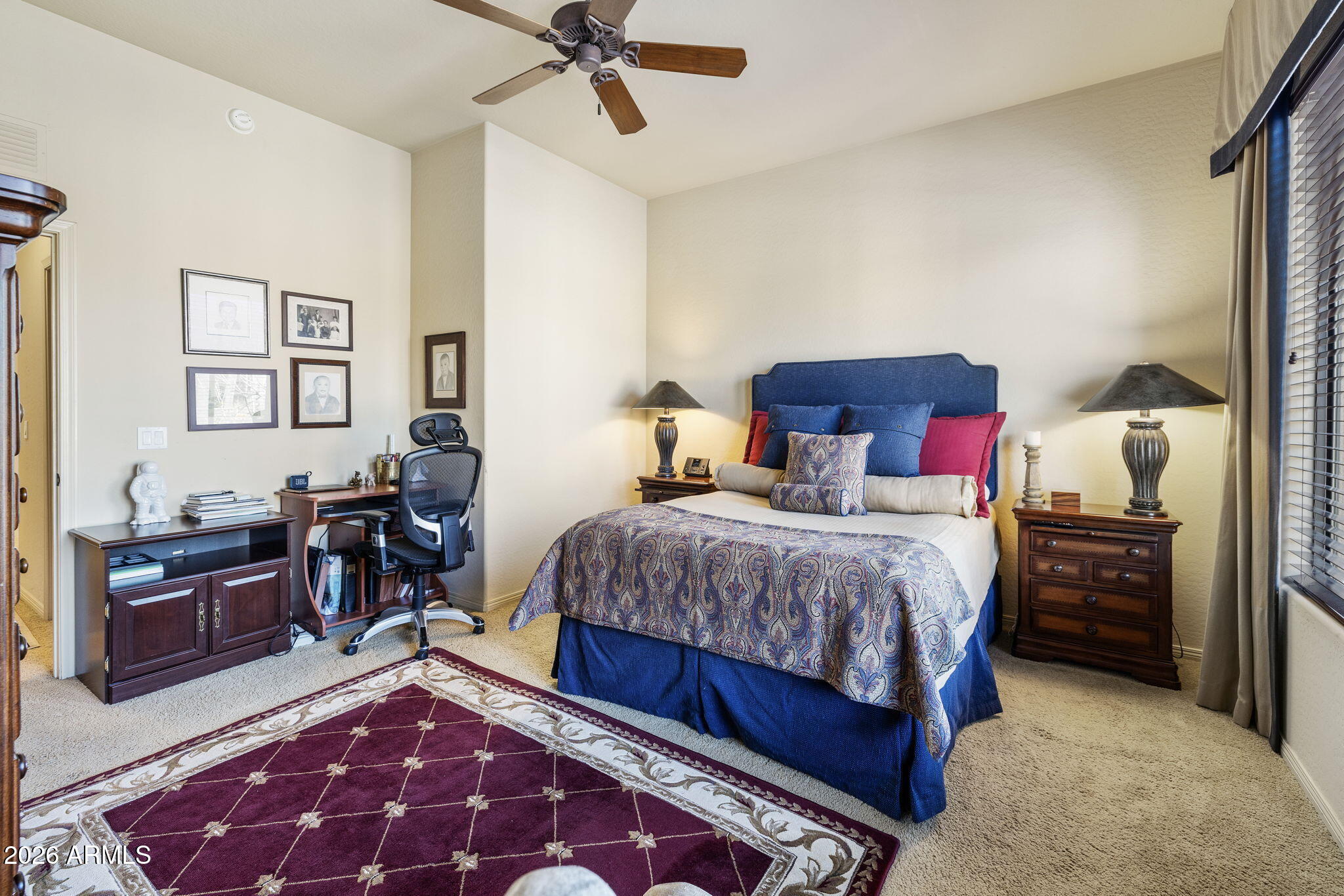2989 North 44th Street, Unit 3018 Phoenix, AZ 85018 - Photo 23 of 45 a bedroom with a bed and wooden floor