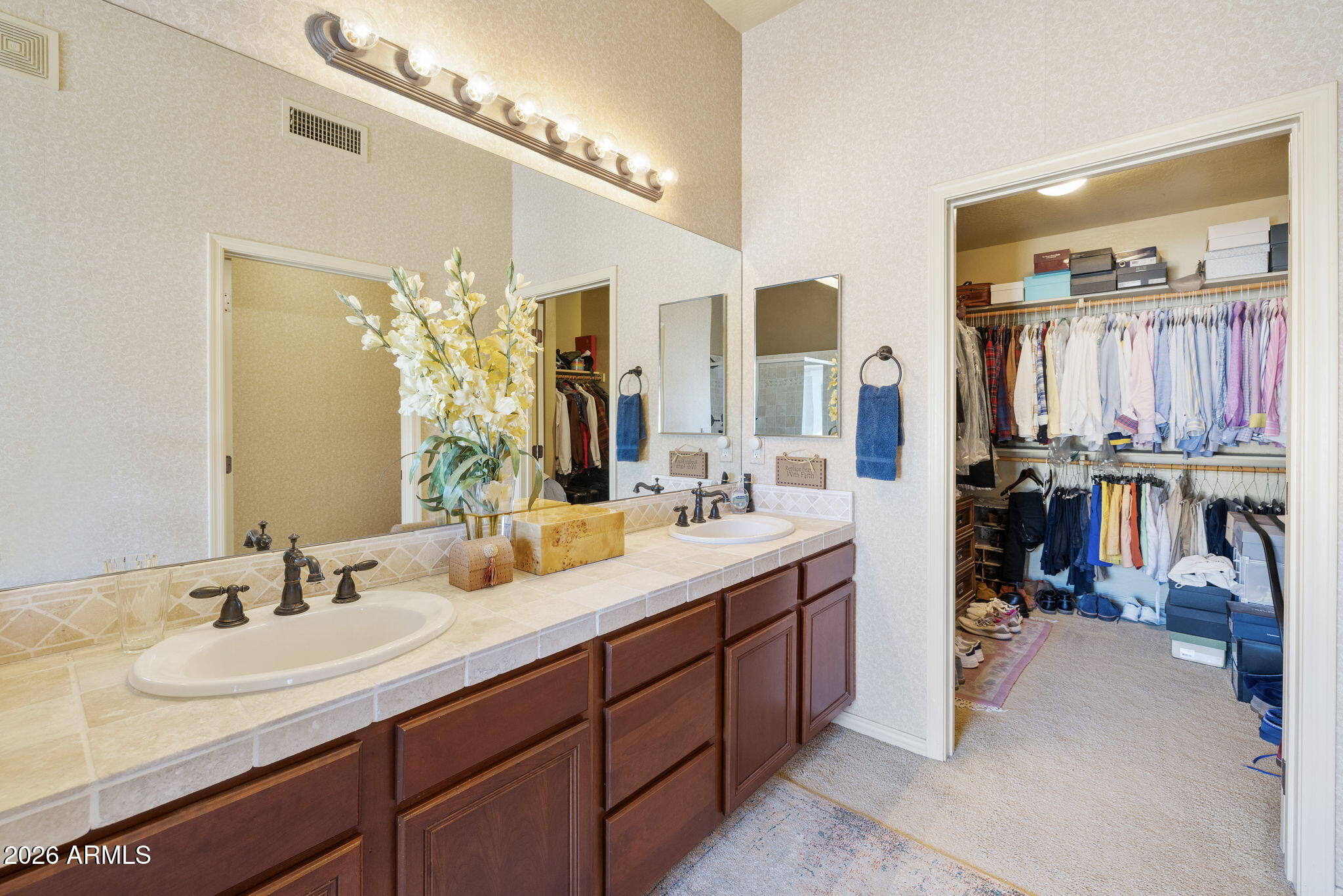 2989 North 44th Street, Unit 3018 Phoenix, AZ 85018 - Photo 24 of 45 a bathroom with a double vanity sink and a mirror