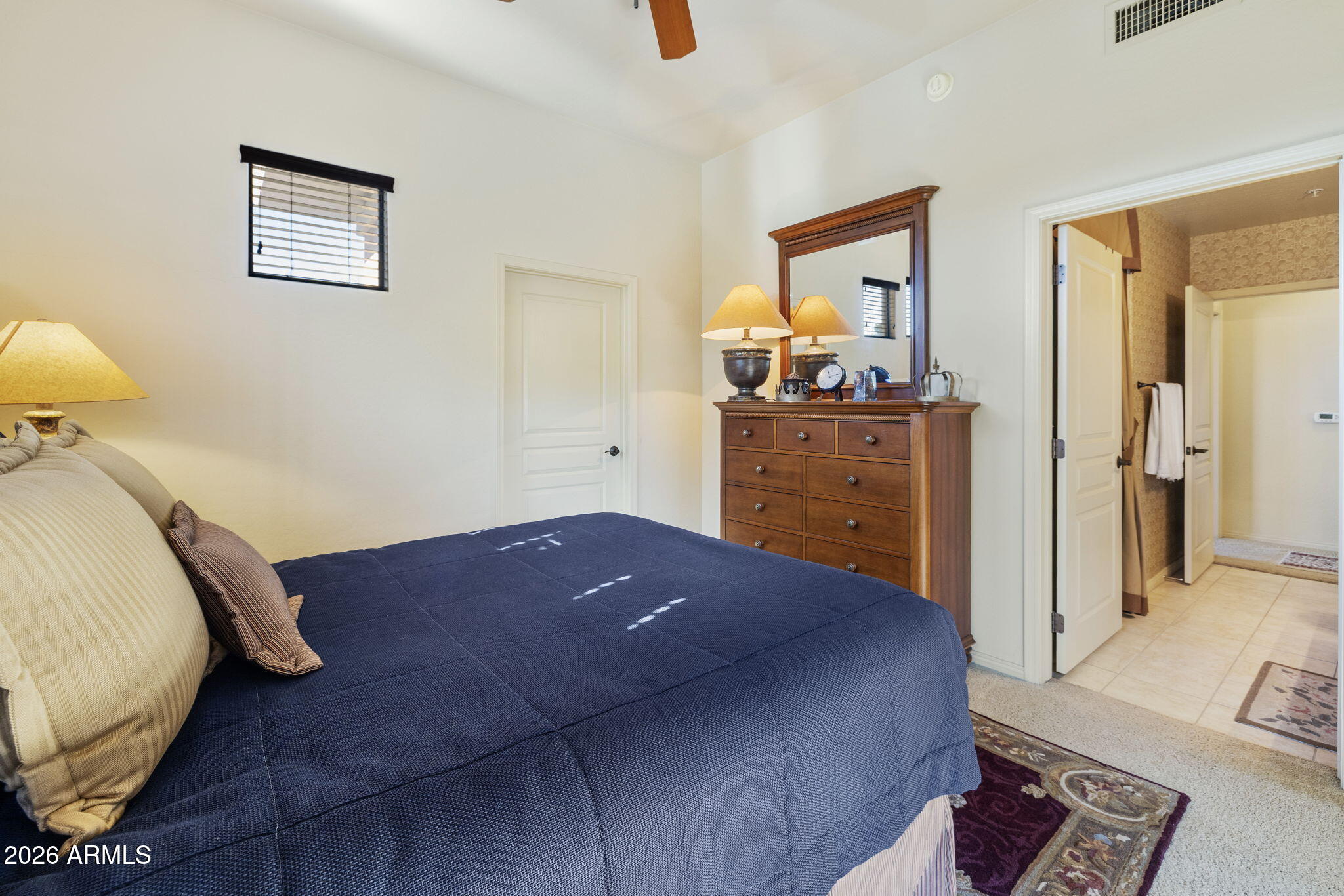 2989 North 44th Street, Unit 3018 Phoenix, AZ 85018 - Photo 28 of 45 a bedroom with a bed and wooden floor